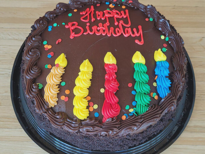 10 on. round chocolate cake with Happy Birthday written in frosting